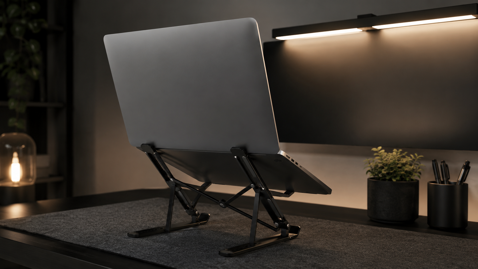 DeskHaus black laptop stand dark minimal desk setup evening lighting
